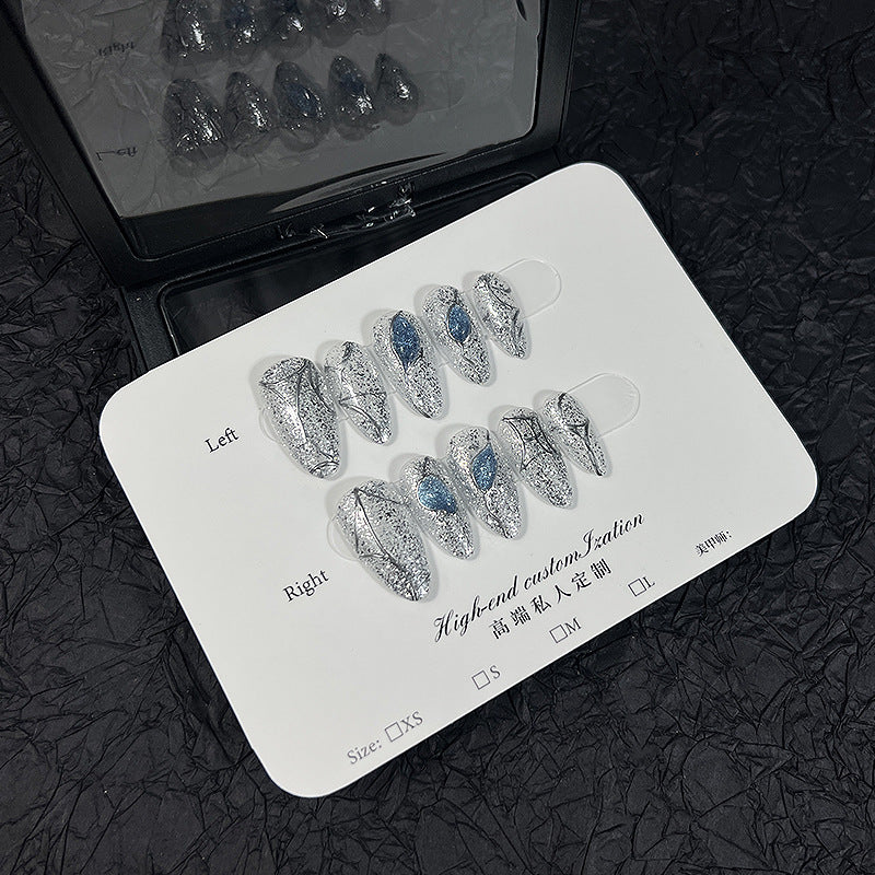 Silver Glitter Cat Eye Press‑On Nails with Blue Gem & Web Design