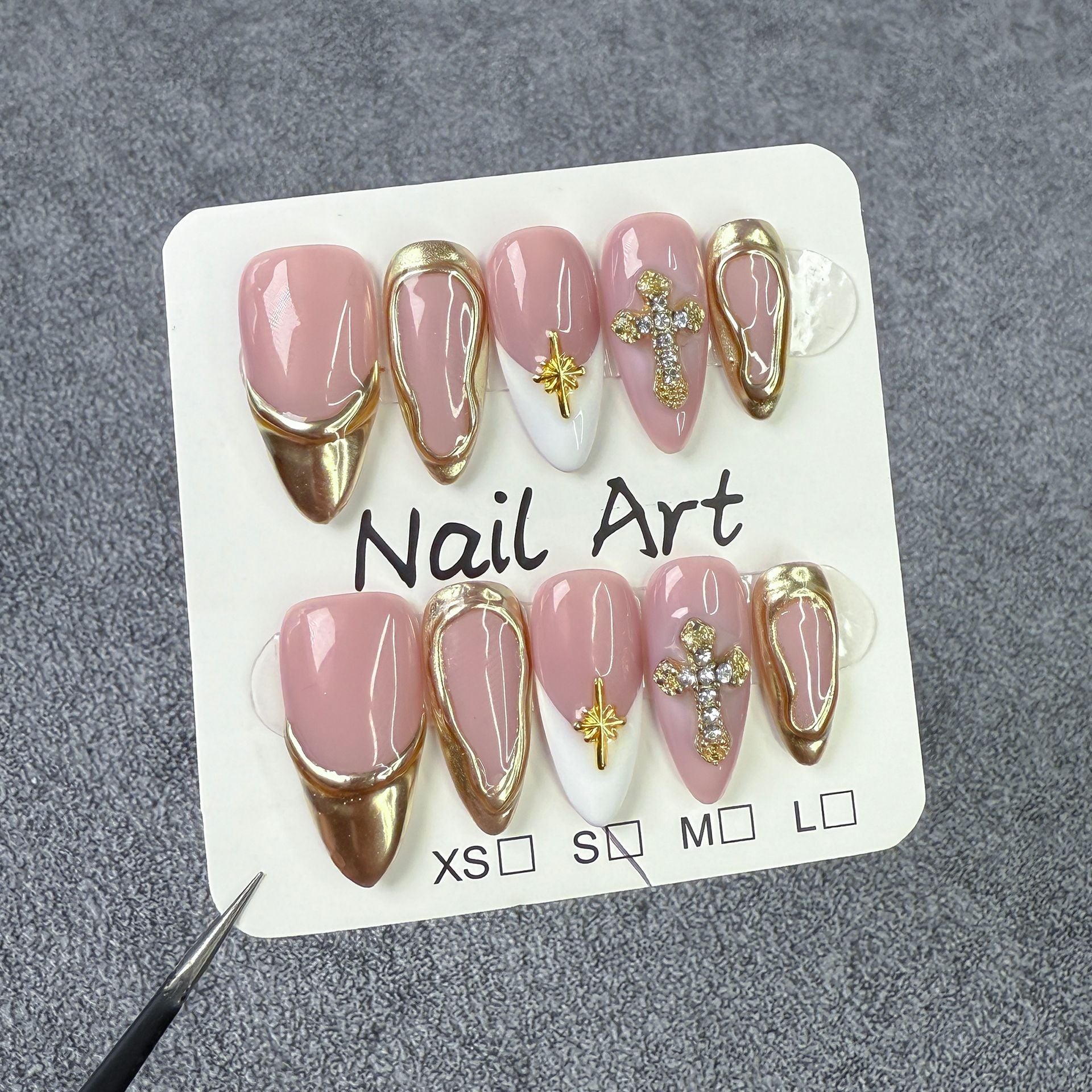 Elegant Gold Frame Blush Nails with Chic Cross Accents