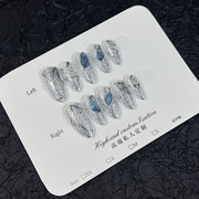 Silver Glitter Cat Eye Press‑On Nails with Blue Gem & Web Design