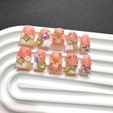 Pink French Nails with Gold Cross and Floral Charms