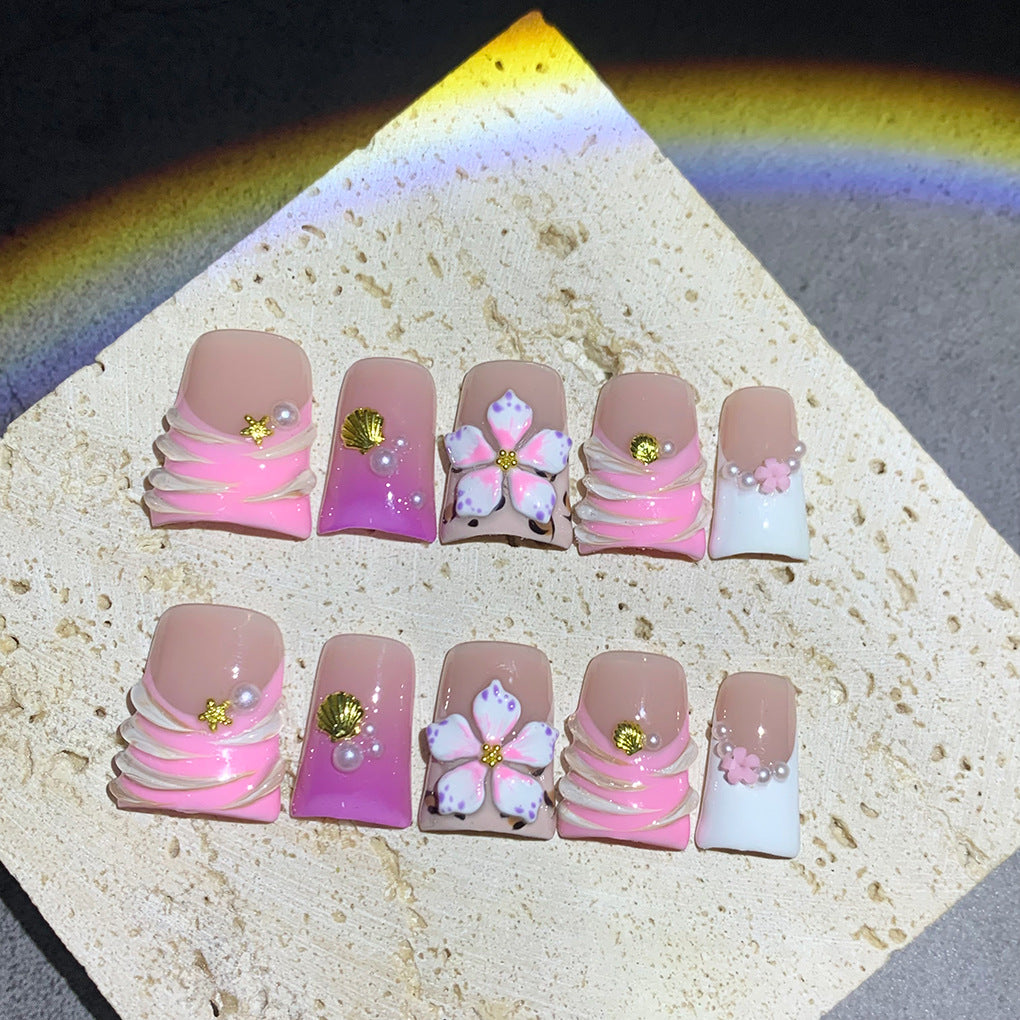 Pink French Nails with Floral Shell Accents and Soft Pearls