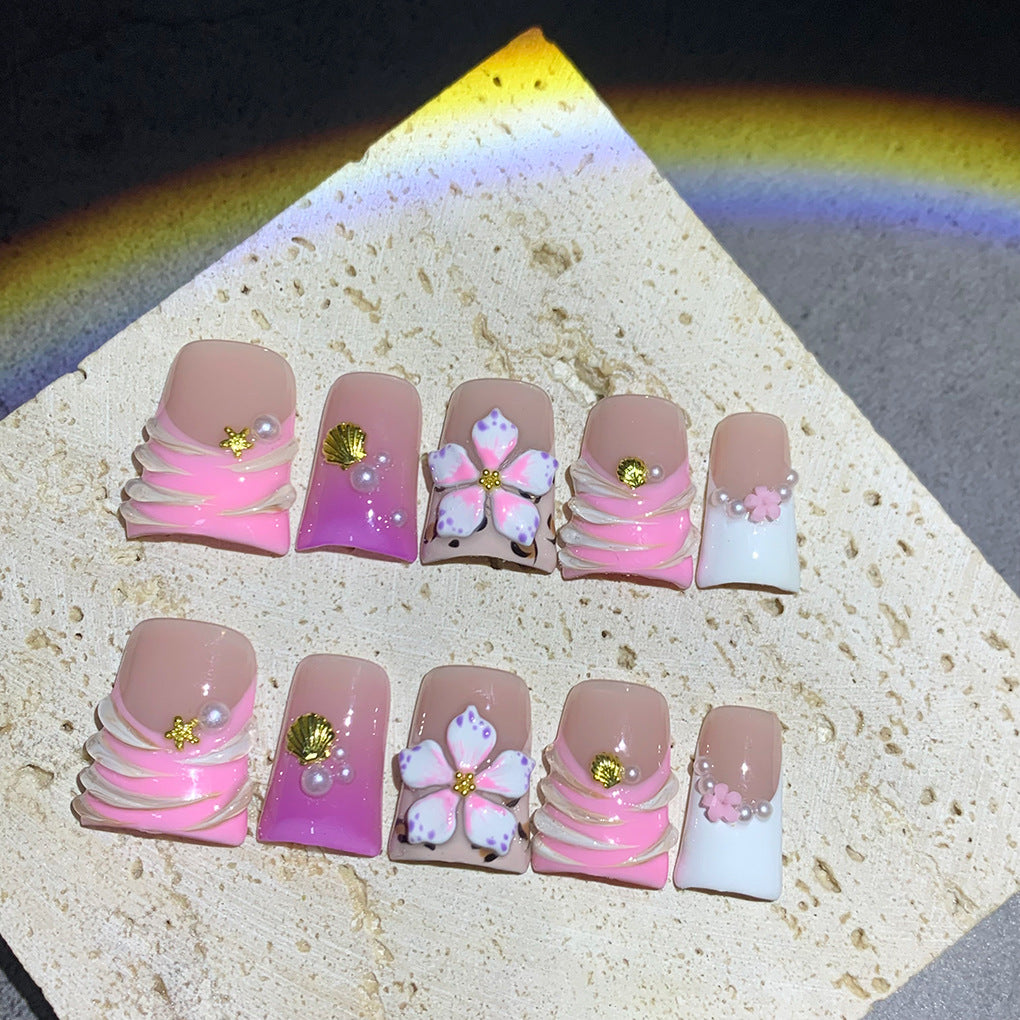 Pink French Nails with Floral Shell Accents and Soft Pearls