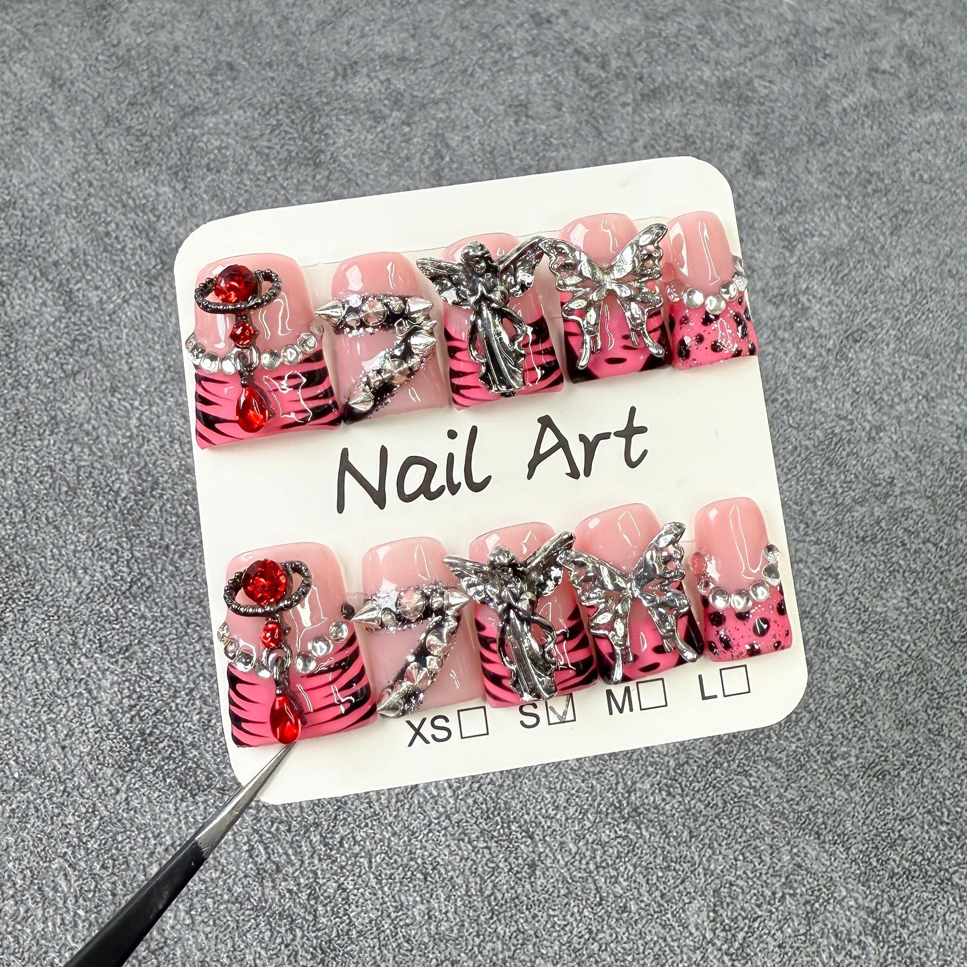 Bold Press-On Nails with Silver Charms and Pink Zebra Design