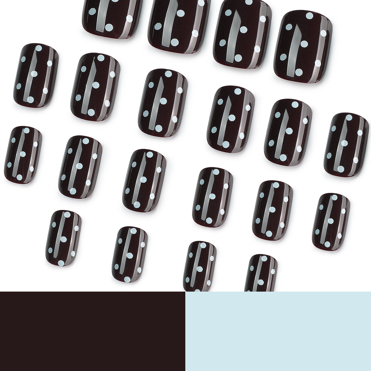Many black press-on nails with white dots on white background