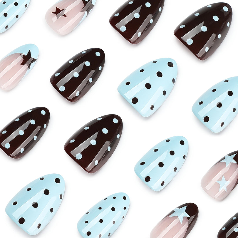 Close-up assortment of glossy press-on nails with star and polka dot designs