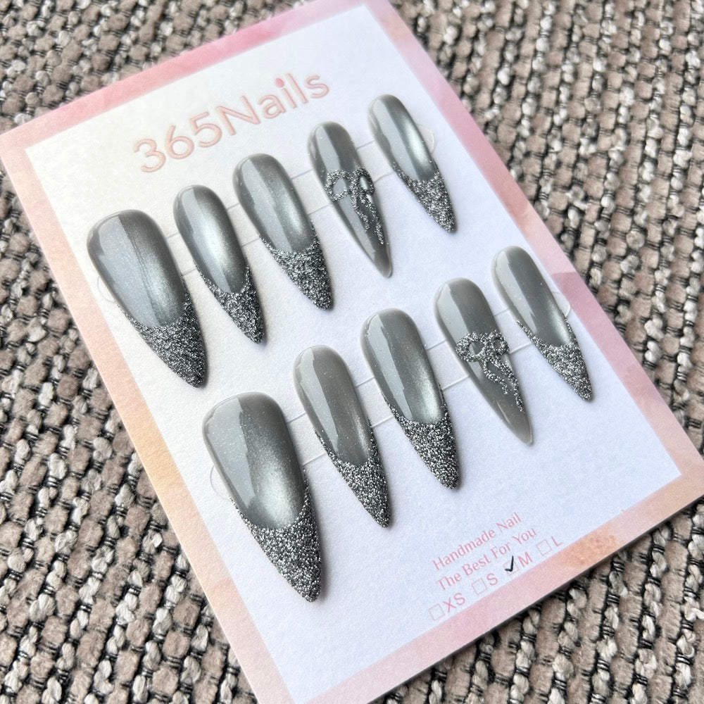 Femme Fatale: "Silver Mist" – Grey Cat Eye with Flash Glitter French Tips & Crystal Bow Charm Long Stiletto Nails