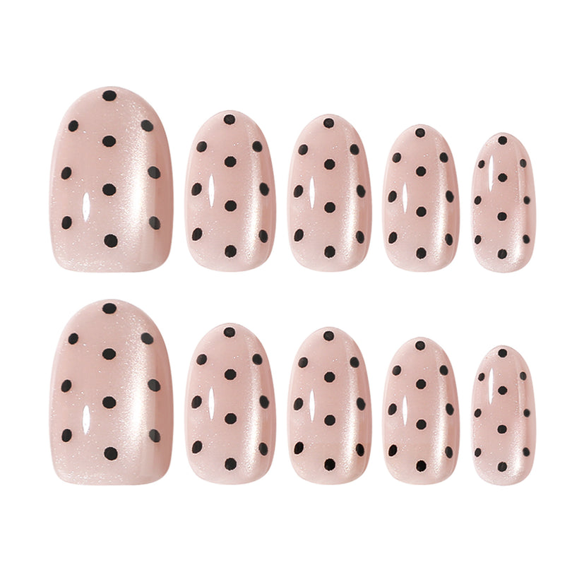 Two rows of pink polka dot false nails in graduated sizes