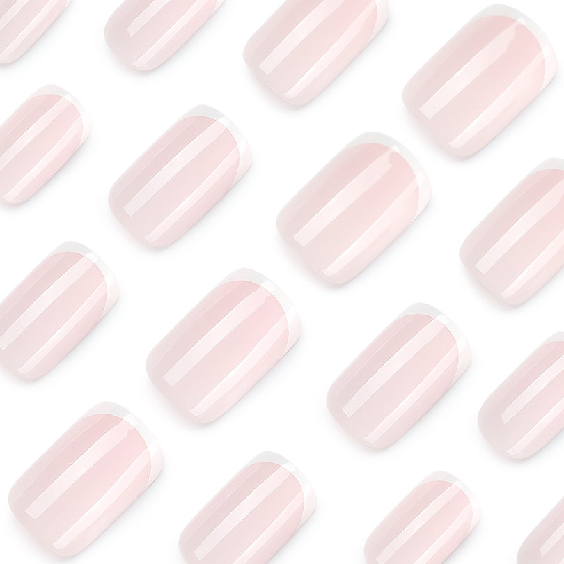 Close-up of pale pink French tip press-on nails