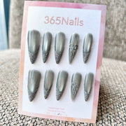 Femme Fatale: "Silver Mist" – Grey Cat Eye with Flash Glitter French Tips & Crystal Bow Charm Long Stiletto Nails