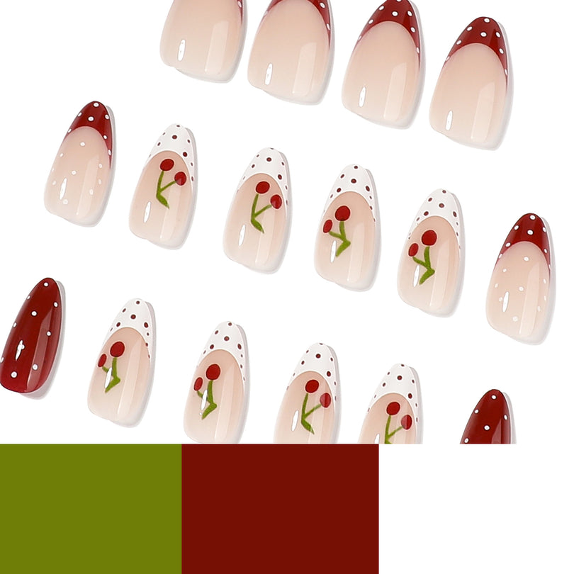 Assorted red and nude cherry press-on nails with polka dots beside green and red color swatches
