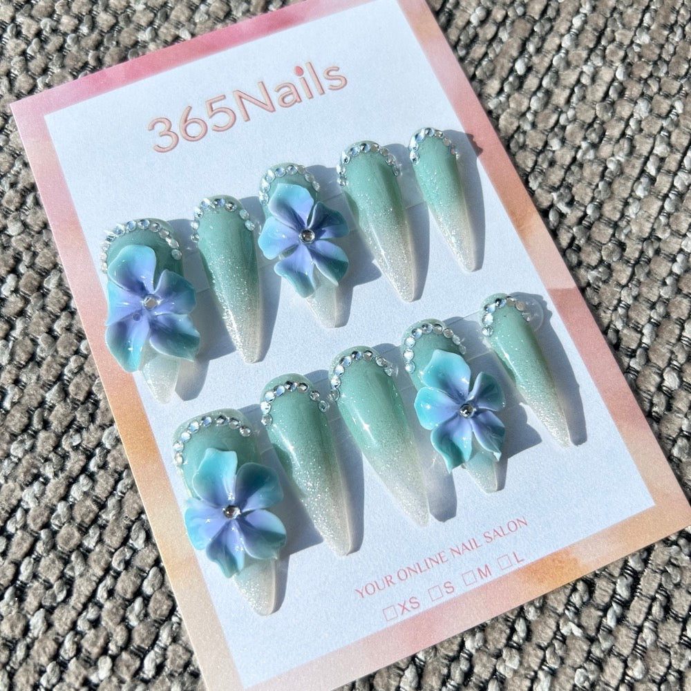 Flora Esculpida: "Orquídea Mística de Menta" – Flores em Degradê Azul-Roxo em 3D em Unhas Stiletto Verde Sálvia com Glitter