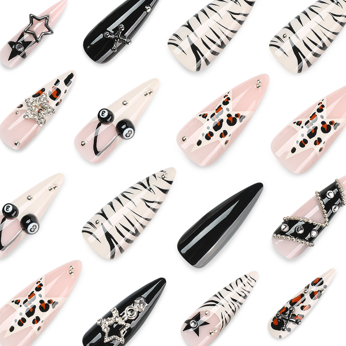 Close-up assortment of press-on nails with gothic stars, crosses, 8-balls and rhinestone charms.