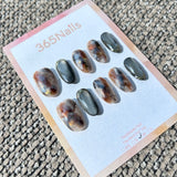 Ethereal Ink: "Gilded Olive Smoke" – Gunmetal Grey Cat Eye & Amber Blue Marble with 3D Gold Chrome Rim Oval Nails