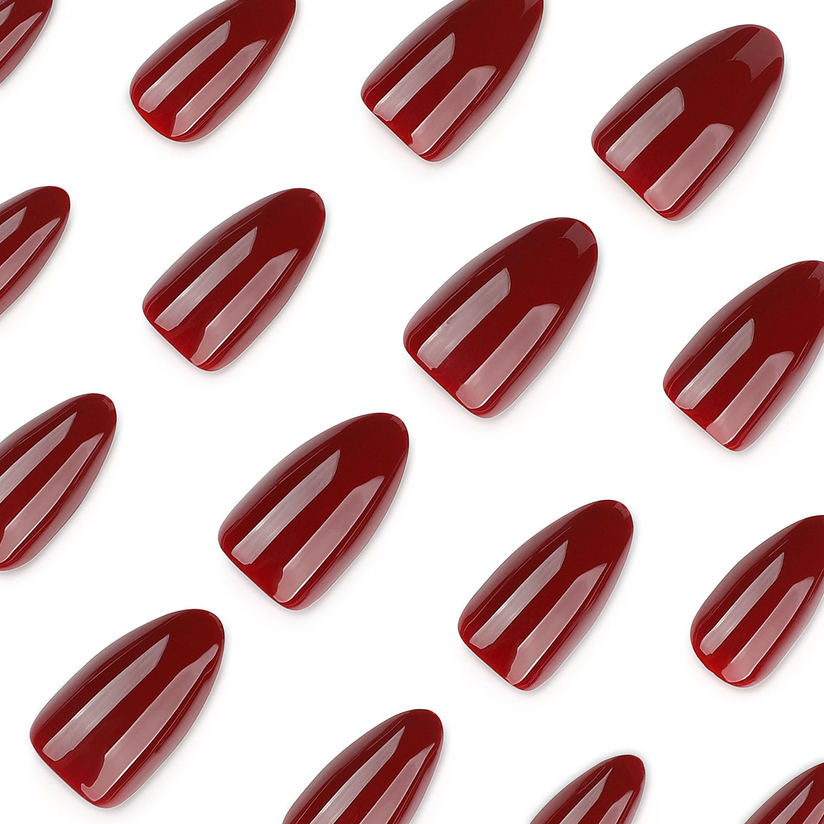 Scattered glossy burgundy almond nail tips on a white background