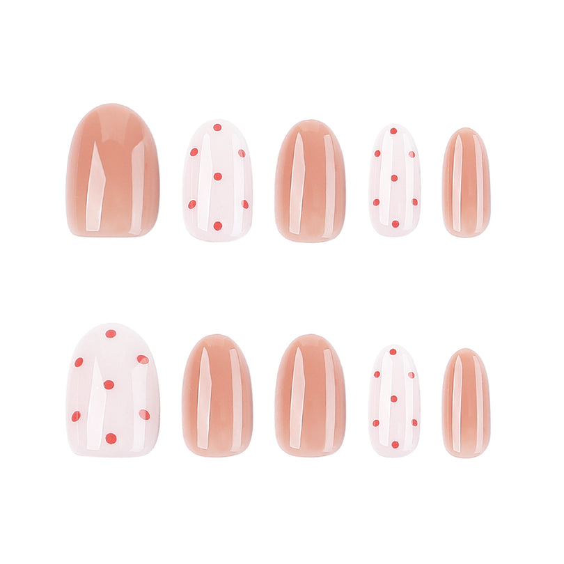 Set of short round press-on nails in pink solid and polka dot styles