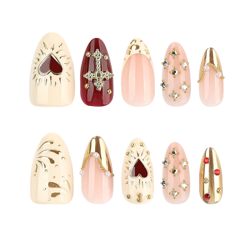 Two-row display of the cream, red, pink and gold press-on nail designs