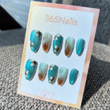 Ethereal Ink: "Magnolia Lake Ripples" – Teal Blue Cat Eye with Hand-Painted White Floral & Amber Ombre Almond Nails