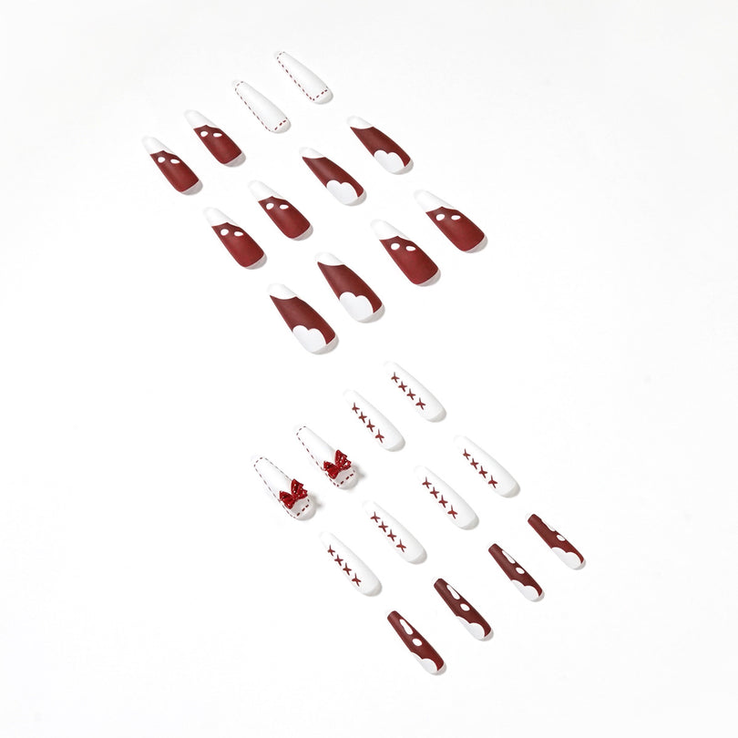 Full set of 24 long coffin press-on nails in red and white designs on white background