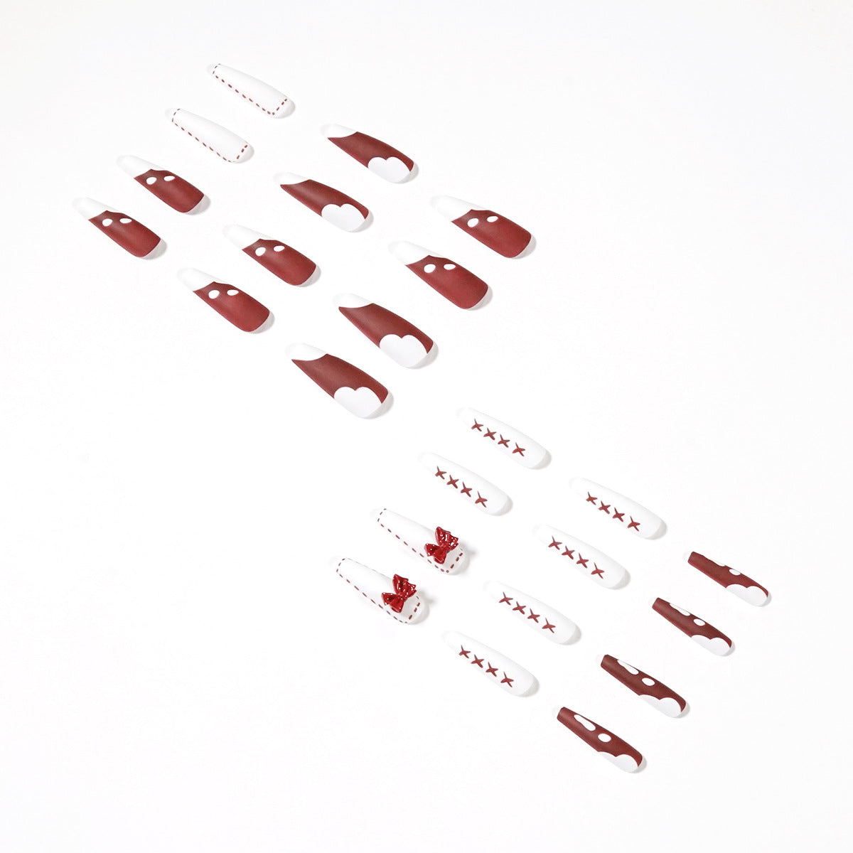 Angled layout of the red and white press-on nail set with bows and X marks