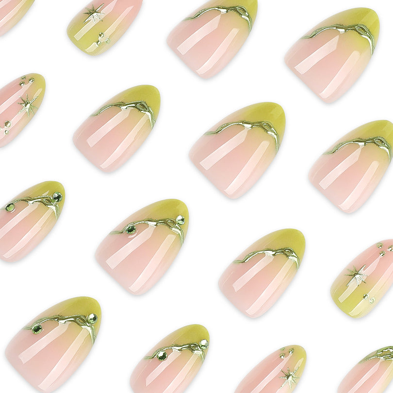 Close-up array of almond press-on nails with green tips and gold details