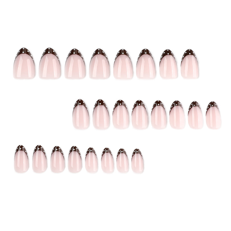Set of 24 almond press-on nails arranged in three rows, pink with brown dotted tips