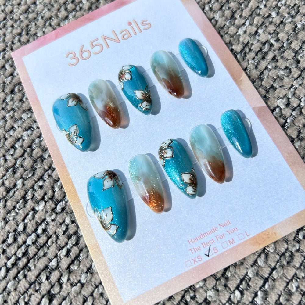 Ethereal Ink: "Magnolia Lake Ripples" – Teal Blue Cat Eye with Hand-Painted White Floral & Amber Ombre Almond Nails