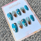 Ethereal Ink: "Magnolia Lake Ripples" – Teal Blue Cat Eye with Hand-Painted White Floral & Amber Ombre Almond Nails