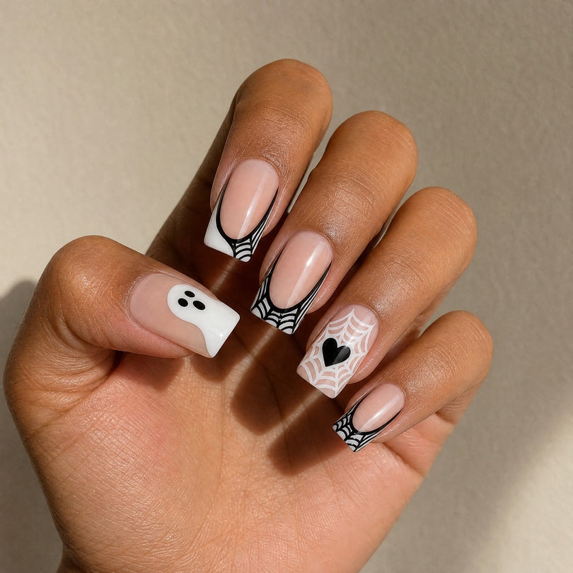 White French black edge ghost press on nails worn on a deep skin tone hand